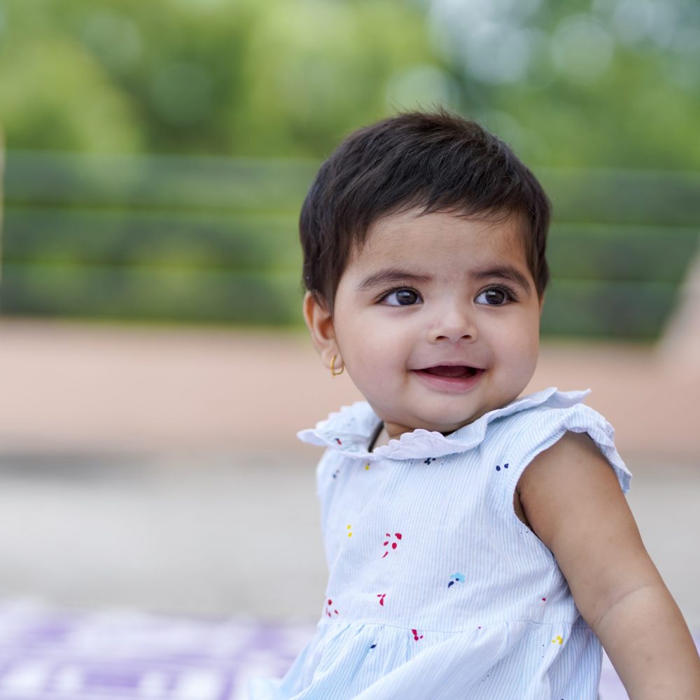 Indian baby girl child playing and giving smile